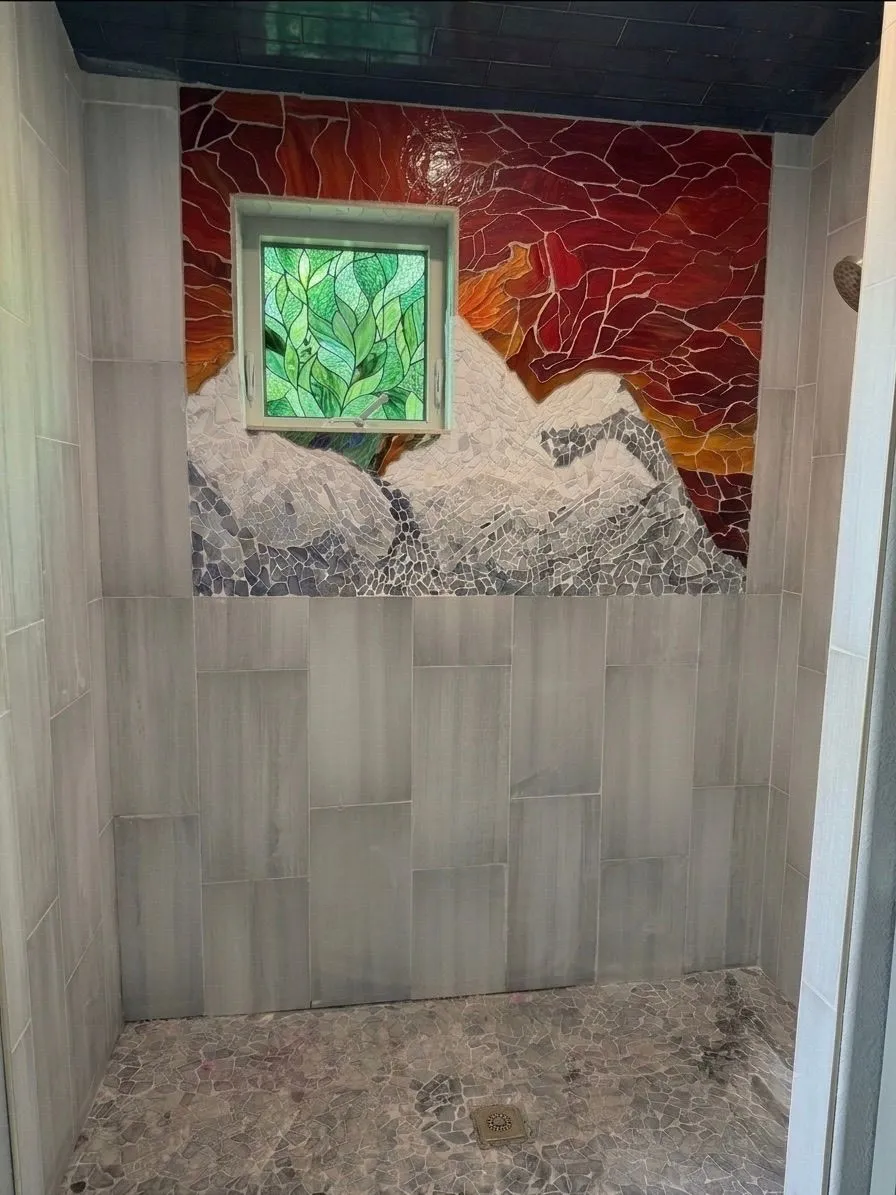 Custom shower with a hand-cut mountain mosaic